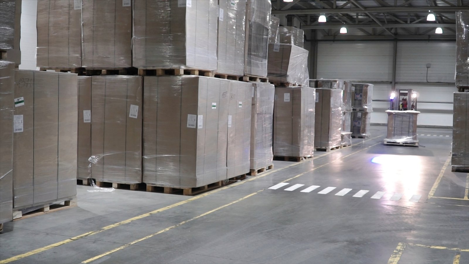 Lift truck in factory. Clip. Wholesale logistic, loading, shipment and people concept - man with